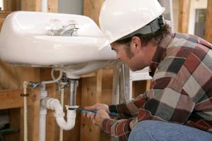 A Glendale Plumbing contractor Installs the J Catch Beneath a Bathroom Sink